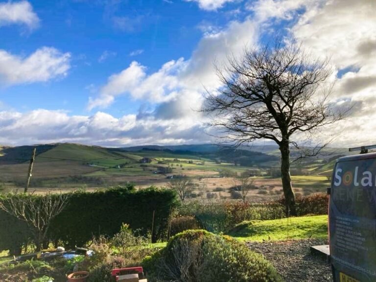 East-west facing solar panels with optimizers and battery storage installed on a rural Wales bungalow roof.